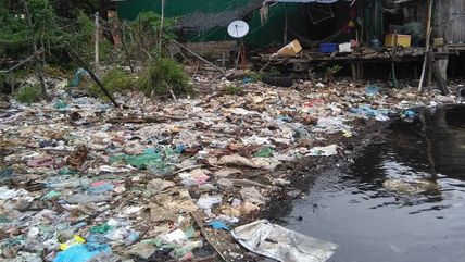 Trash accumulating at the banks of a coastal fishing village in Cambodia.